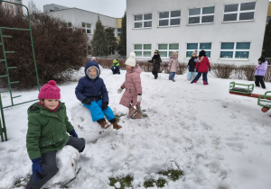 Dzieci bawiące się śniegiem na dworze